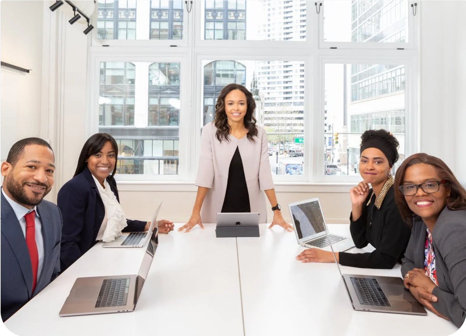 A group of women and a man in an office
